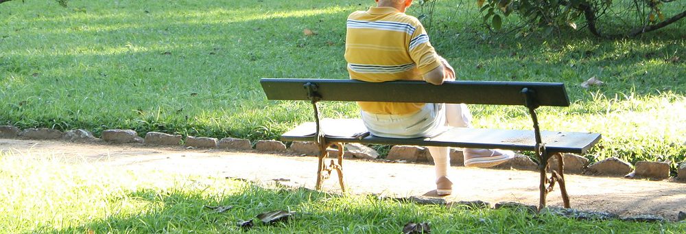 Man relaxing on a bench in the sun